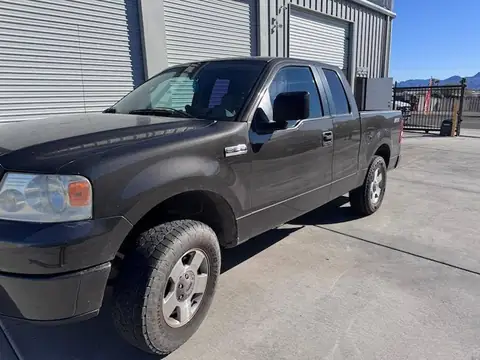 2000 Ford F-150 window tint: Removal of purple faded tint on rear 3 windows, New 5% Carbon rear 3 windows, 20% front doors, 3% windshield strip