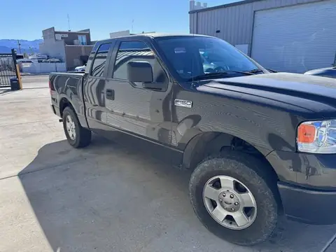 2000 Ford F-150 window tint: Removal of purple faded tint on rear 3 windows, New 5% Carbon rear 3 windows, 20% front doors, 3% windshield strip (view 3)