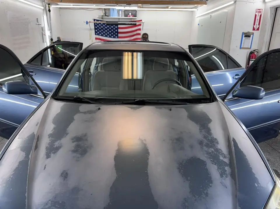 2004 Toyota Camry window tint: Wrapped up in our 15% C-IR on sides and rear window and a 5% Sunstrip before they get a full color change wrap done (view 2)