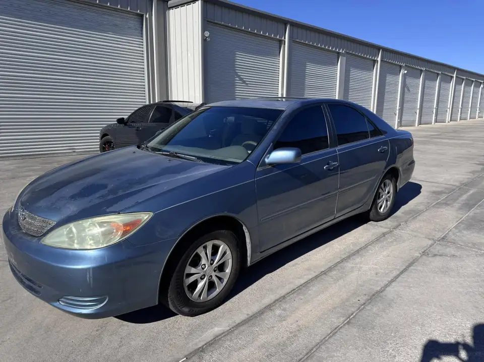 2004 Toyota Camry window tint: Wrapped up in our 15% C-IR on sides and rear window and a 5% Sunstrip before they get a full color change wrap done (view 4)