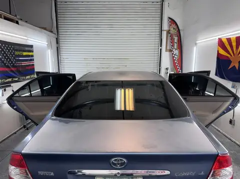 2004 Toyota Camry window tint: Wrapped up in our 15% C-IR on sides and rear window and a 5% Sunstrip before they get a full color change wrap done (view 6)
