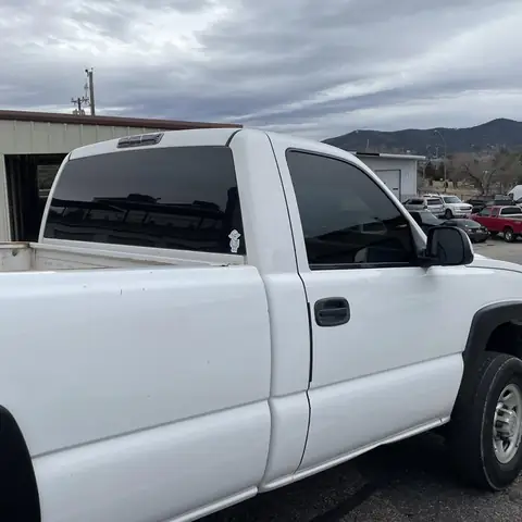 2006 Chevy 1500 single cab window tint: Old peeling faded tint removed, Premium double 5% rear window, Premium 25% sides, 5% upper and lower strips (view 2)