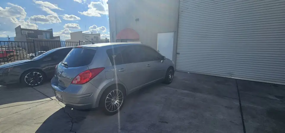 2011 Nissan Versa hatchback window tint: Installed 5% on rear half of the car, Installed 3% Windshield Visor Strip (view 2)