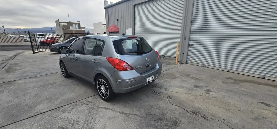 2011 Nissan Versa hatchback window tint: Installed 5% on rear half of the car, Installed 3% Windshield Visor Strip (view 3)