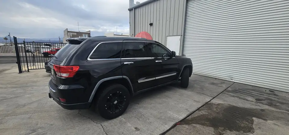 2012 Jeep Grand Cherokee window tint: 5% all sides with a 3% Windshield Visor Strip (view 3)