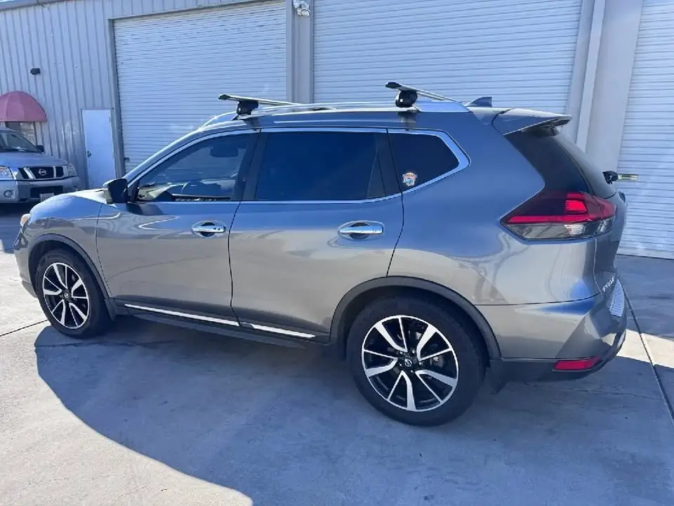 2018 Nissan Rogue window tint: 40% over rear half privacy windows (8% read), 20% front door windows, 3% windshield strip (view 3)