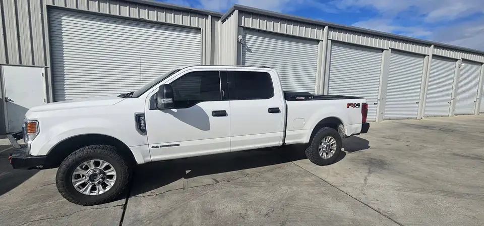 2020 Ford F-250 window tint: Remove old tint from front door windows, Installed 20% on front 2 door windows, Installed 40% on Windshield (view 2)