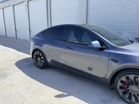 2023 Tesla Model Y window tint: Remove 15% from 2 fronts and installed new 5%, Remove 5% from sunroof and installed new 35% over factory privacy glass