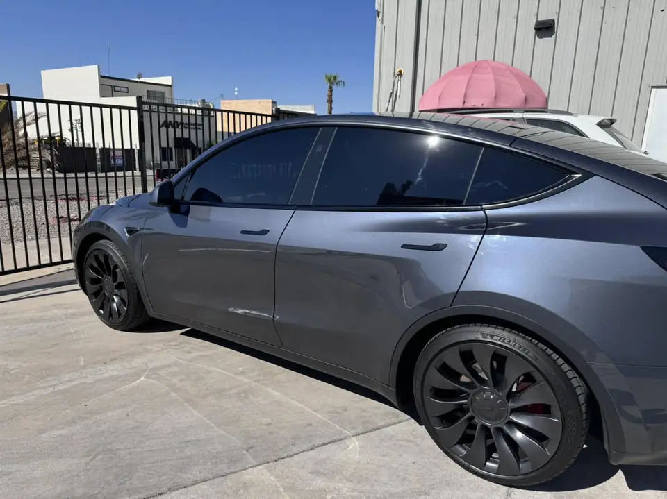 2023 Tesla Model Y window tint: Remove 15% from 2 fronts and installed new 5%, Remove 5% from sunroof and installed new 35% over factory privacy glass (view 4)