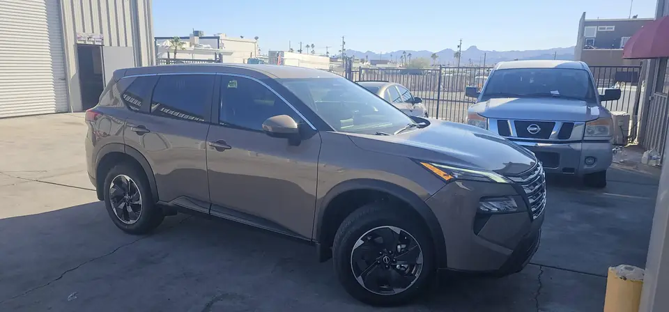 2024 Nissan Rogue window tint: 20% Carbon On Front 2 Windows, 5% Carbon on all Rears, 5% Carbon Visor Strip (view 3)