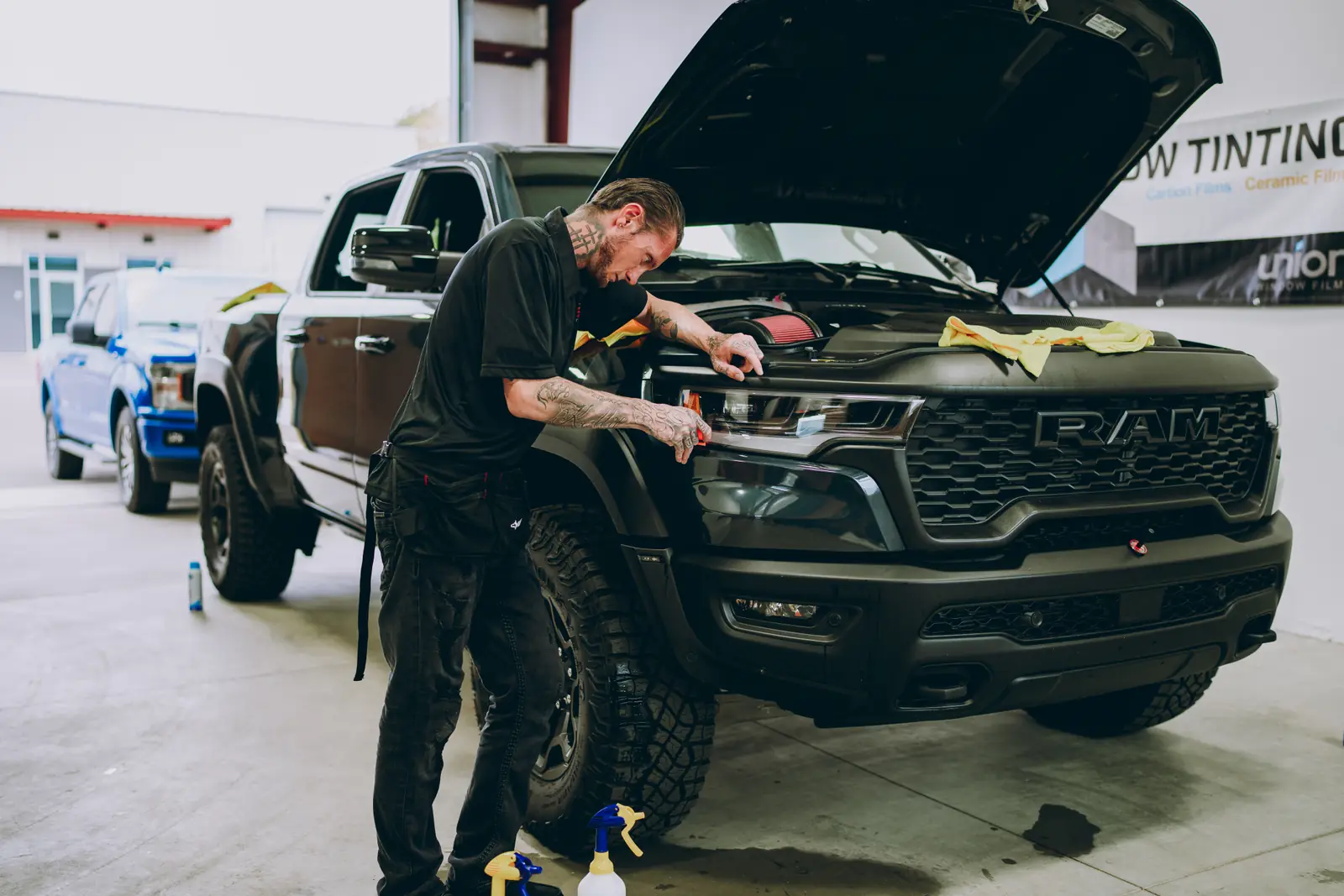 2026 Ram 1500 RHO paint protection film: Stage 2 paint protection film: the front quarter of the hood, the front quarter of both fenders, and the rocker panels front to rear, done at the shop in Prescott Valley