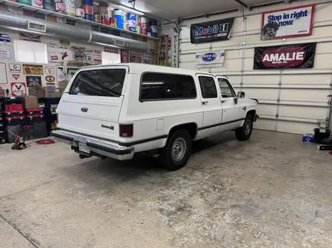 Classic Chevy Suburban window tint: Installed 5% on the two front doors and the rear hatch, Installed 15% on the rear doors and rear cargo windows (view 2)
