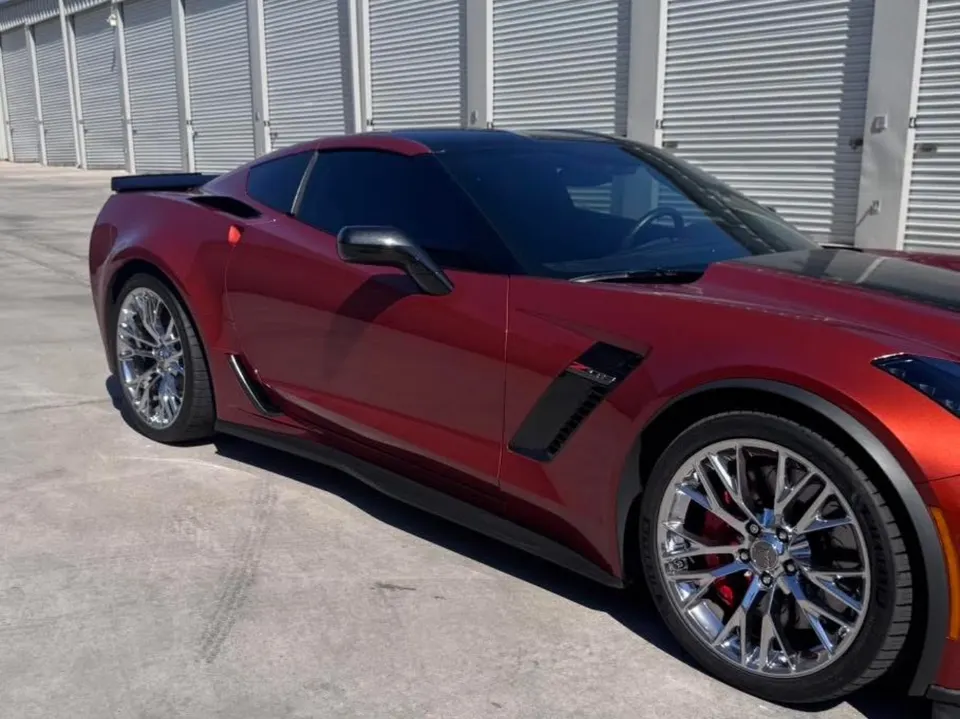 Red Chevrolet Corvette with dark window tint