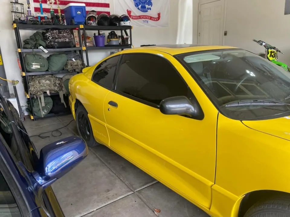 Yellow sport coupe with dark tint in the shop