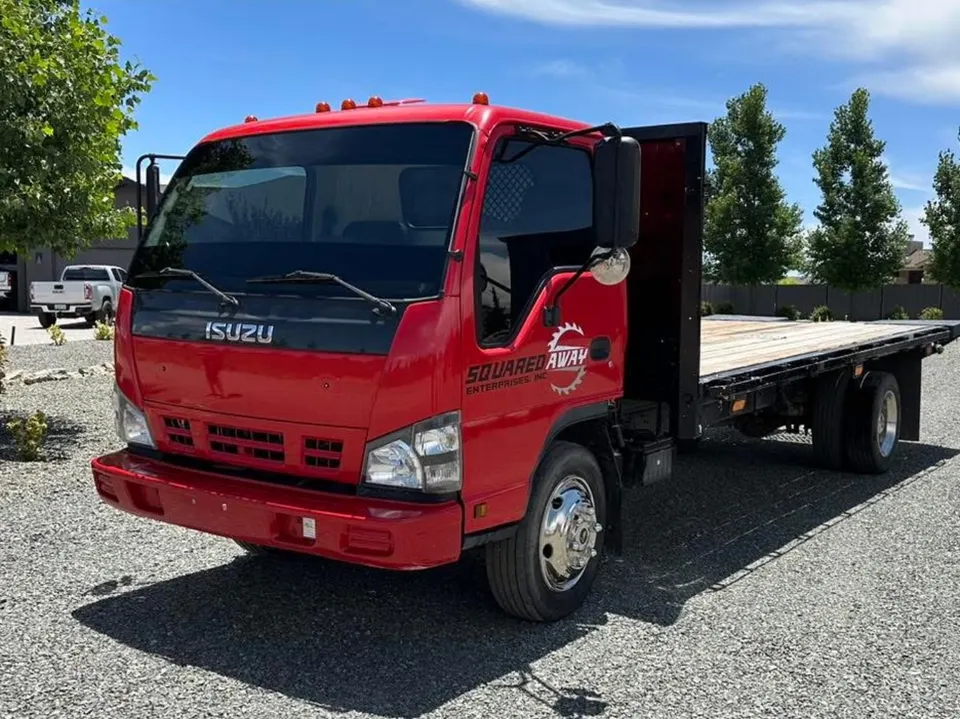 Red flatbed work truck with tinted cab