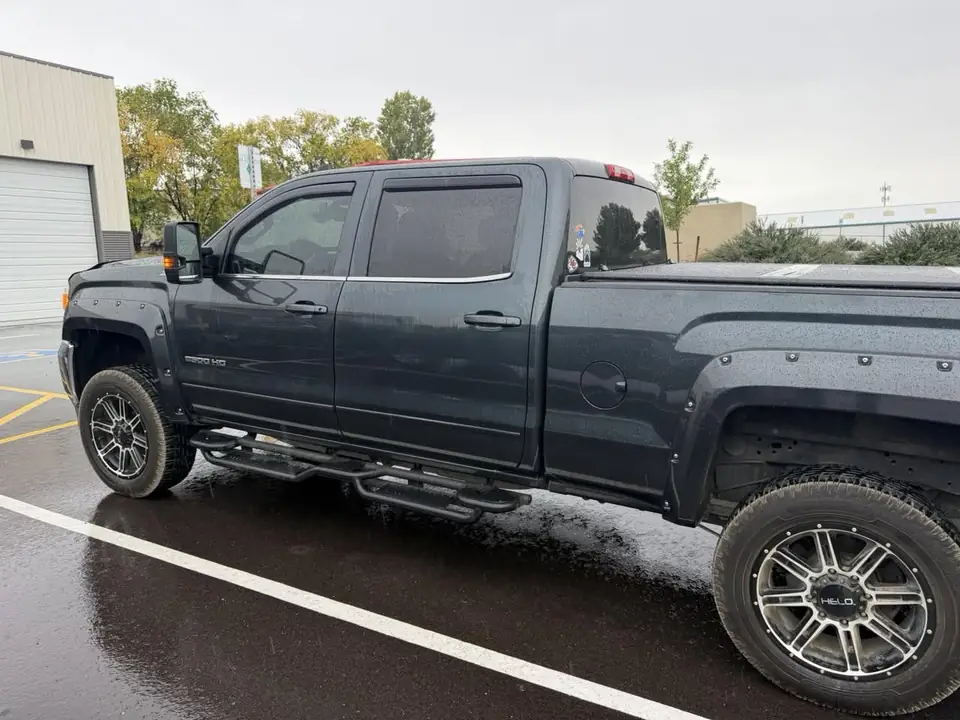 GMC Sierra 2500HD window tint: Removed the old failing dyed film and installed 35% carbon on the front two doors, at the shop in Prescott Valley (view 2)