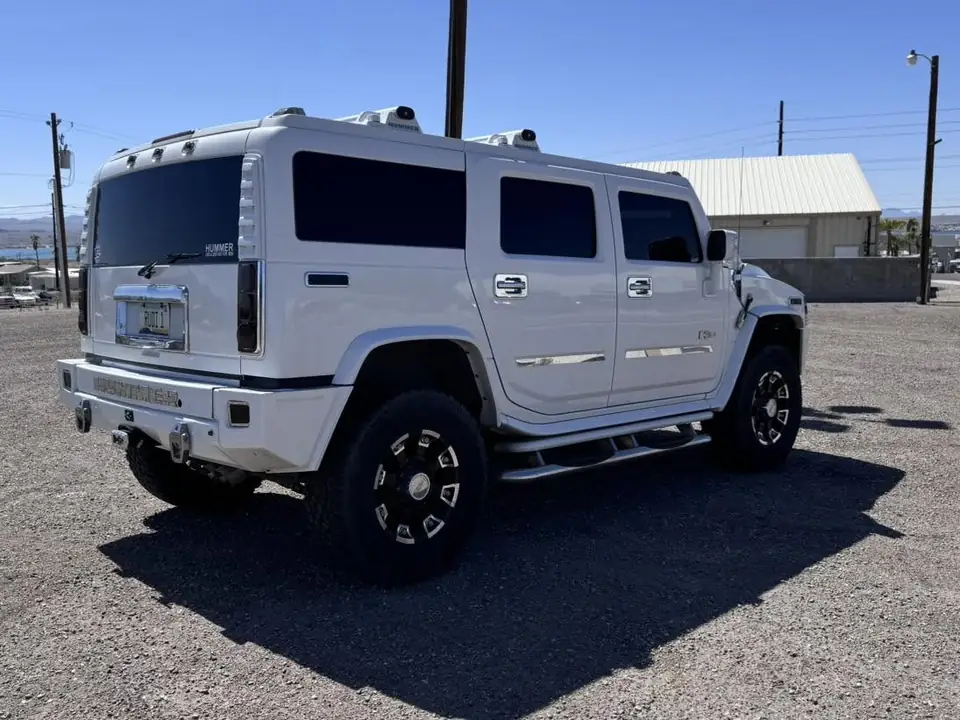 Hummer H2 window tint: Full removal of old film, New 5% ceramic sides and rear, 50% full windshield, 5% sunstrip (view 2)