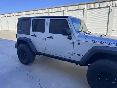 Jeep Wrangler Rubicon window tint: Removed film from front doors, Installed new 5% C-IR over the rear half privacy windows, 15% C-IR on the front