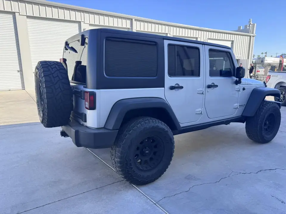 Jeep Wrangler Rubicon window tint: Removed film from front doors, Installed new 5% C-IR over the rear half privacy windows, 15% C-IR on the front (view 2)