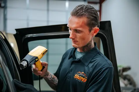 Jonny heat-shrinking tint film in the 928 Tint shop