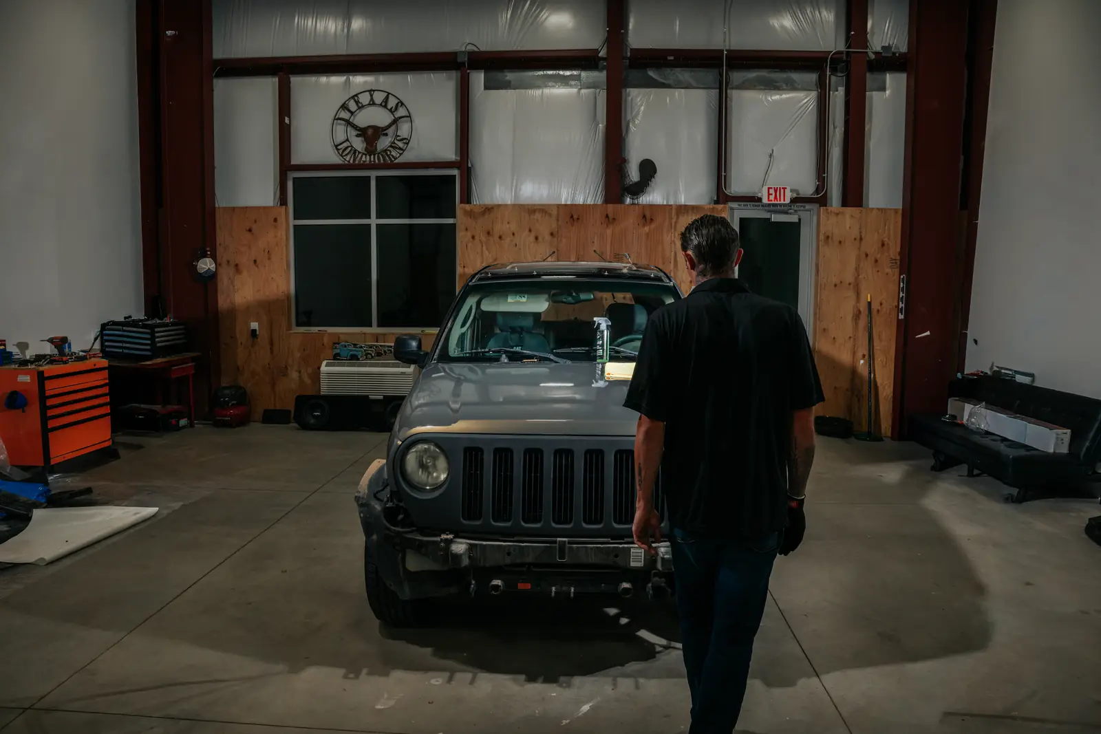 Jonny walking up to a Jeep in the 928 Tint install bay