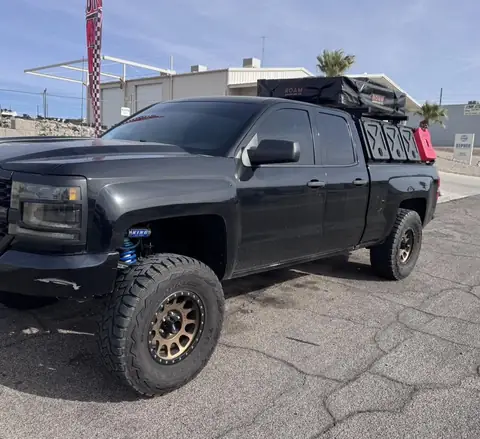 Lifted Chevy pickup window tint: 5% C-IR all around and sunstrip (view 2)