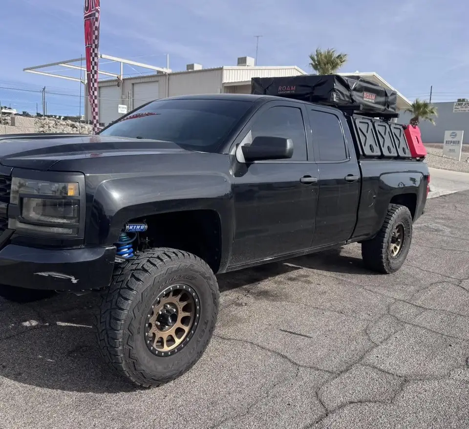 Lifted Chevy pickup window tint: 5% C-IR all around and sunstrip (view 2)