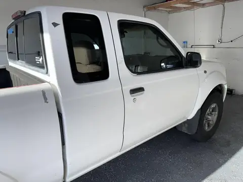 Nissan Frontier window tint: Remove old bubbly tint on front doors, New 35% installed on front doors (view 2)