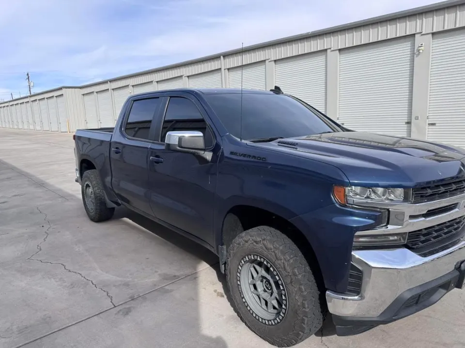 Blue Chevy Silverado crew cab with tinted windows