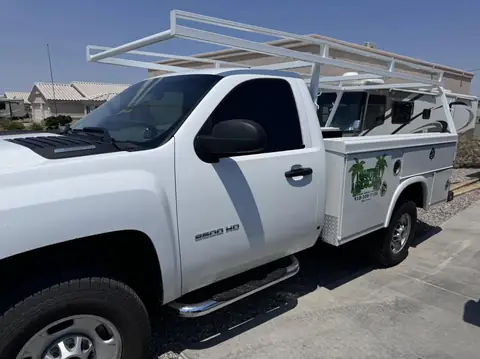 Two Chevy work trucks, window tint: 15% carbon ceramic rear window, 20% carbon ceramic side windows (view 2)