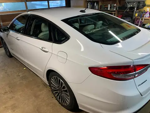 White sedan window tint: 5% on back doors and rear windshield and visor