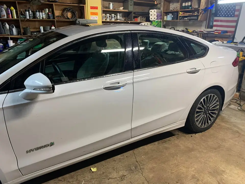 White sedan window tint: 5% on back doors and rear windshield and visor (view 2)