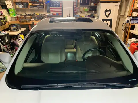 White sedan window tint: 5% on back doors and rear windshield and visor (view 3)