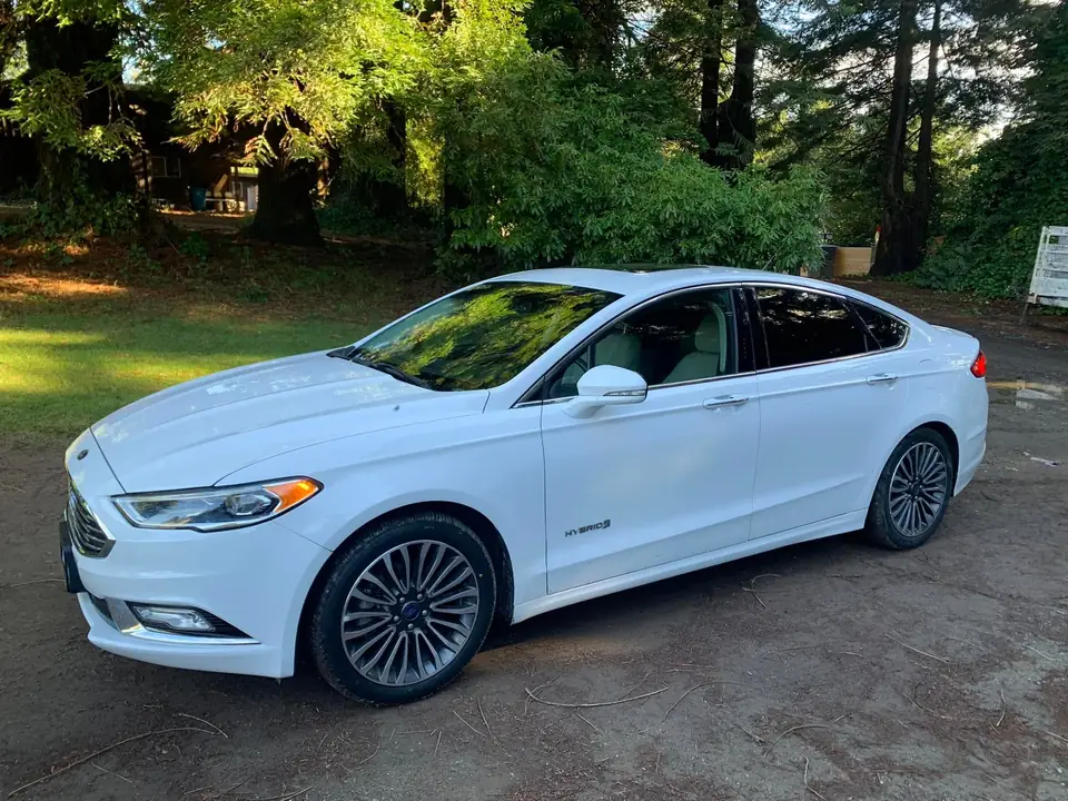 White sedan window tint: 5% on back doors and rear windshield and visor (view 4)