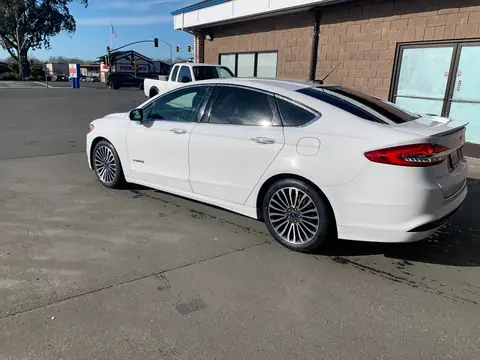 White sedan window tint: 5% on back doors and rear windshield and visor (view 5)