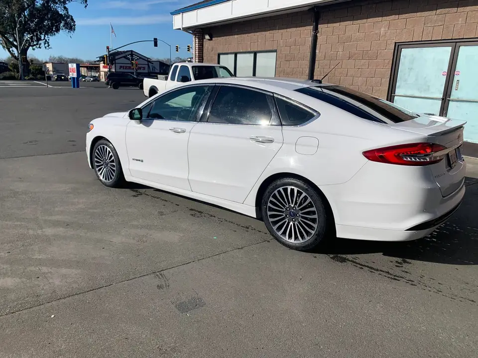 White sedan window tint: 5% on back doors and rear windshield and visor (view 5)