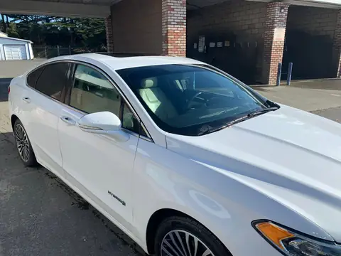 White sedan window tint: 5% on back doors and rear windshield and visor (view 6)