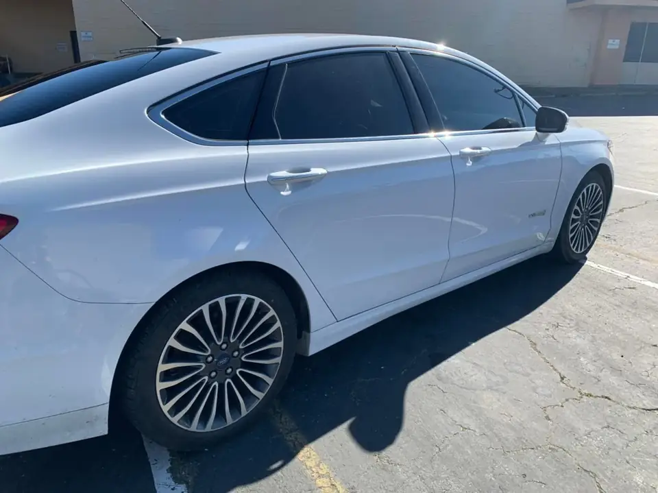 White sedan window tint: 15% on the front roll ups (view 2)